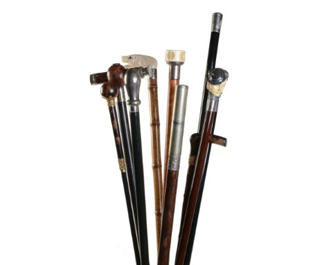 ϒA collection of ten various walking sticks, late 19th and 20th century, including a bamboo example with handle carved as the