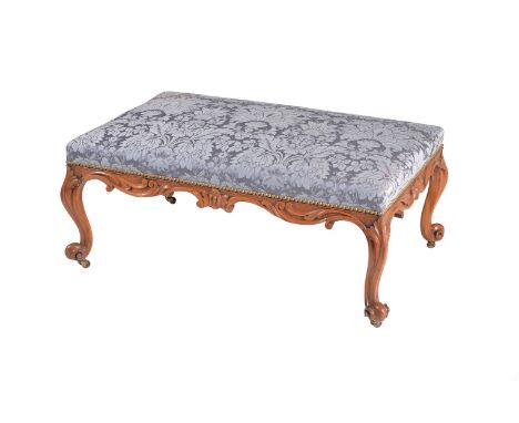 A Victorian walnut rectangular centre stool, circa 1870, with padded seat and scroll carved apron, on cabriole legs with scro