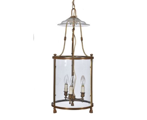 A gilt metal and glazed cylindrical hall lantern in Regency taste, elements late 19th century and later, the bowed panes belo