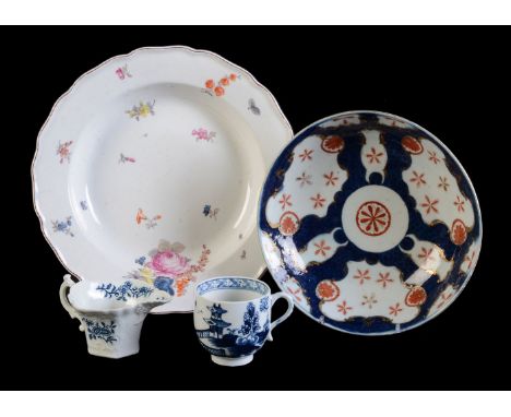 A Chelsea porcelain soup plate, circa 1756, painted with deutsche Blumen, within a brown-line rim, 23cm diameter; a Lowestoft
