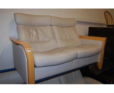 A Stressless beech framed and cream leather upholstered twin reclining sofa