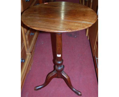 An early 19th century mahogany circular fixed top pedestal tripod table