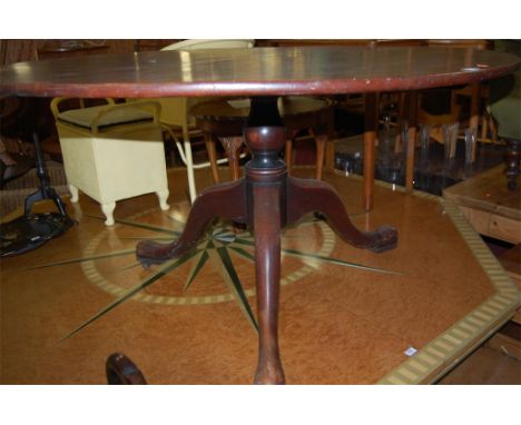 An unusually large George III mahogany circular pedestal tilt top tripod table