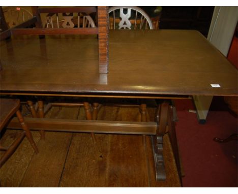 An Ercol mid elm dining table together with a set of six elm seat and beech wheelback chairs (7)