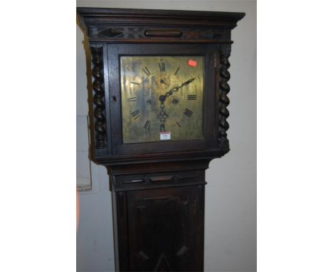 An early 20th century geometric moulded oak long case clock having square brass dial, twin weight driven movement