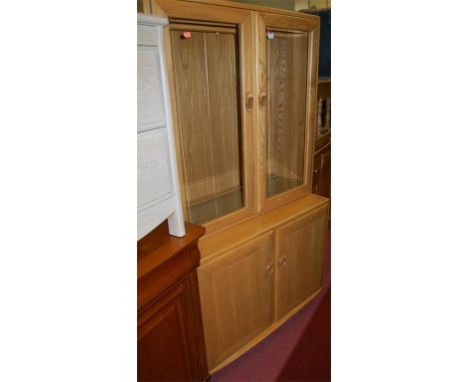 A modern Ercol light elm display cabinet