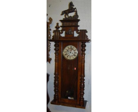 An early 20th century walnut Vienna drop trunk wall clock