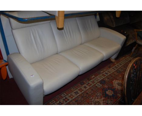 A Stressless beech framed and cream leather upholstered triple reclining sofa