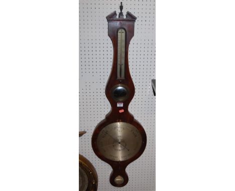 An early 19th century mahogany and satinwood strung four dial wheel barometer