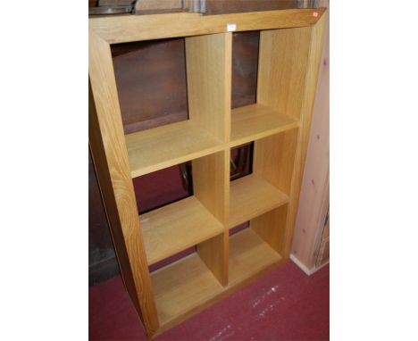 A modern light oak freestanding open display shelf