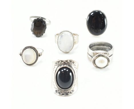 An assorted collection of silver stone set rings. The lot to include; moonstone cabochon to planished metal tapering shank (9