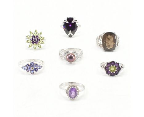 An assorted collection of silver &amp; purple stone set rings. The lot to include; amethyst &amp; white stone halo ring (925)