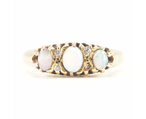 A hallmarked 9ct gold, opal and diamond ring. The ring being set with three graduating oval opal cabochons with four diamond 