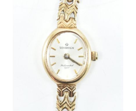 A hallmarked 9ct yellow gold Sovereign cocktail wrist watch. The watch having an oval champagne coloured sunburst dial with g