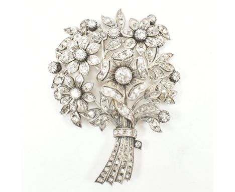 A 1920s diamond brooch pin. The brooch in the form of a bouquet of flowers set with old cut and rose cut diamonds having roll