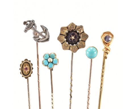 A collection of gold stick pins. The stick pins to include, turquoise flower, amethyst, ruby, and silver anchor. Total weight