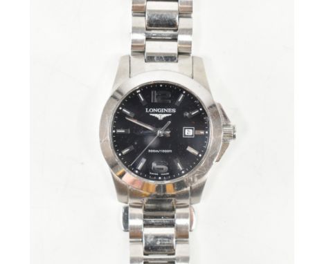 A Longines Conquest stainless steel wrist watch. The watch having a circular black dial with mixed silver tone Arabic &amp; w