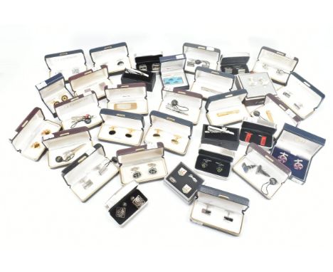 An assorted collection of boxed cuff links, money clips &amp; tie pins. The lot to include; gold &amp; silver tone metal, hin