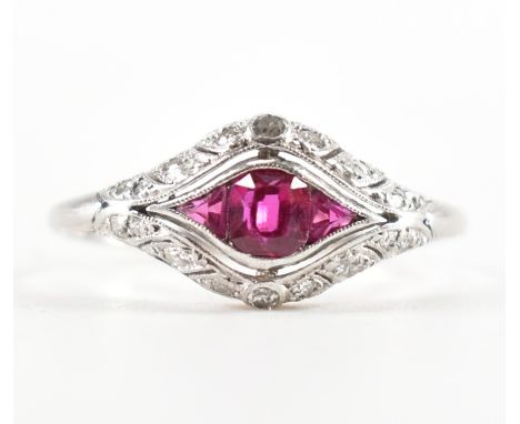 A platinum, spinel &amp; diamond ring. The ring set with central calibre cut spinel framed by single cut diamonds in a pierce