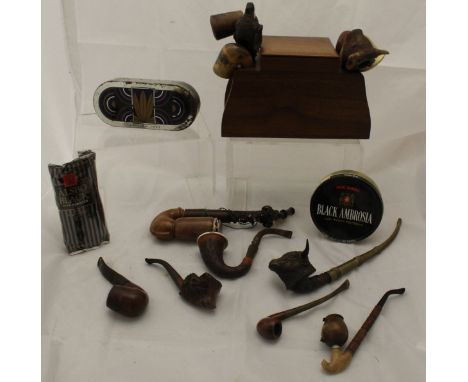 A large collection of various wooden pipes to include some with the pipe bowl in the form of a bull or other animal heads, to