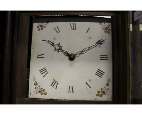 An oak cased long case clock with Roman numerals to the enamel dial and floral sprays to the spandrels