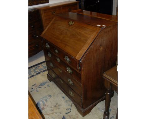 A George III mahogany bureau, the sloping fall enclosing a fitted interior over four long graduated drawers to bracket feet