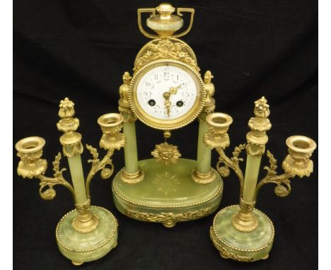 A French onyx and gilt brass cased clock garniture, the 8-day movement by Mougin with floral painted white enamel dial and Ar