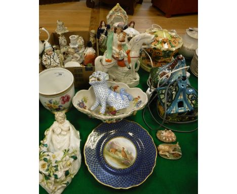 A collection of various china wares to include Staffordshire style clock group, Staffordshire spaniel, Staffordshire figure o