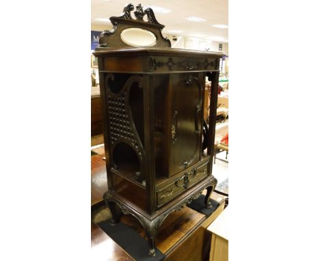 An Edwardian mahogany music cabinet in the Rococo style, a fall front mahogany music cabinet, two pedestal occasional tables,