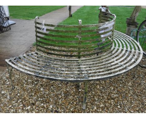 A painted metal demi-lune tree bench