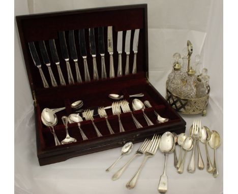 A plated cruet frame with various glass bottles, a collection of plated cutlery and a modern mahogany canteen of plated cutle