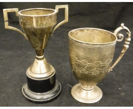 A Victorian silver cup with all over engine turned decoration and open cartouche with scrolling handle and acanthus decoratio