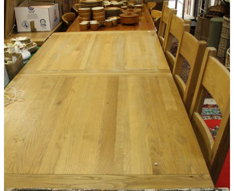 A light oak extending rectangular dining table on square section legs, together with six ladder back chairs   CONDITION REPOR