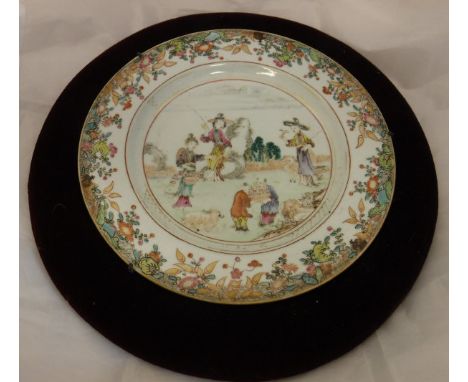 An early 19th Century Chinese polychrome decorated plate, the central panel decorated with figures and goat in a garden setti