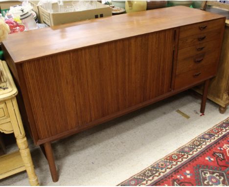 A teak sideboard by SØborg MØbler of Denmark, the plain top above a tambour fronted cupboard and a bank of five short drawers