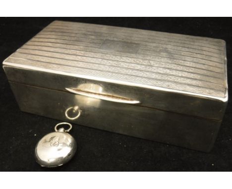 A George V silver mounted cigarette box (Birmingham 1924) with engine turned decoration and initials to the cartouche, togeth