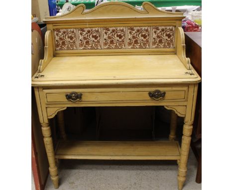 A Victorian pine washstand with three-quarter galleried top and tiled back and painted decoration, the plain top above a sing