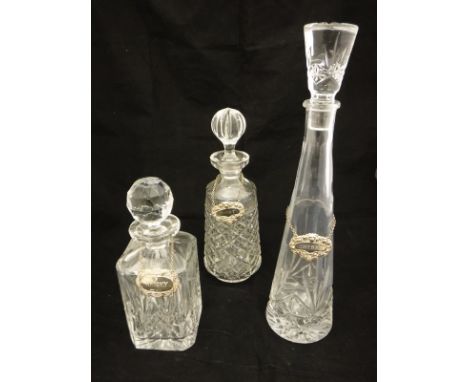 Two pairs of Caithness crystal coloured glass wines, three decanters with bottle tags, pair of Dartington candlesticks, vario