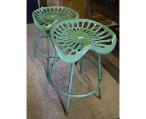 A pair of modern painted adjustable stools in the form of vintage tractor seats*