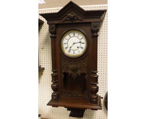 A circa 1900 oak cased Continental wall clock, the 8-day movement with white enamel dial and Roman numerals