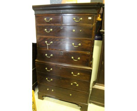 A 19th Century mahogany chest on chest with moulded pediment with Greek key moulding above two short over three long drawers 