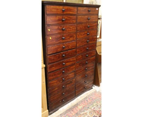 A Victorian mahogany chest of twenty four drawers, each inscribed with letters of the Alphabet, (missing letters: Q, X and Z 
