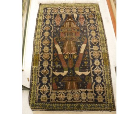 A Belouch Prayer rug, the central panel set with architectural motifs on a blue ground, within a stepped blue and green geome