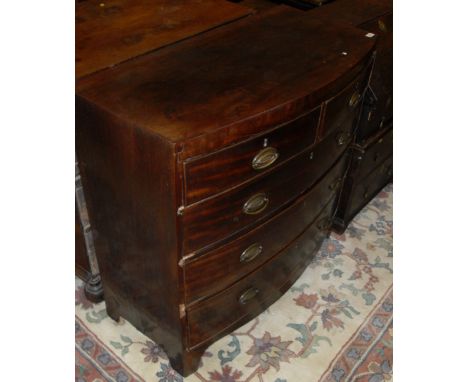 A Victorian mahogany bow front chest, the plain top above two short and three long drawers with brass handles raised on brack