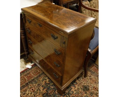 A modern walnut bachelors chest in the 18th Century manner, the fold-overtop opening onto lopers over four long drawers to br