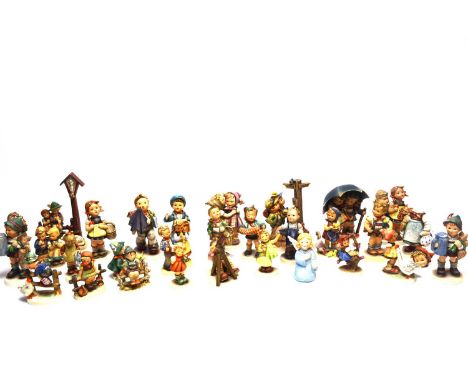 A collection of Goebel Hummel figures, including: an angel; a postman; a boy looking through a telescope; a pair of hikers at
