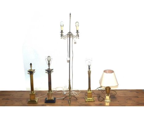 A modern gilt floor standing lamp, modelled as a twin branched candelabra, with decorative brass curtain ties draped around t