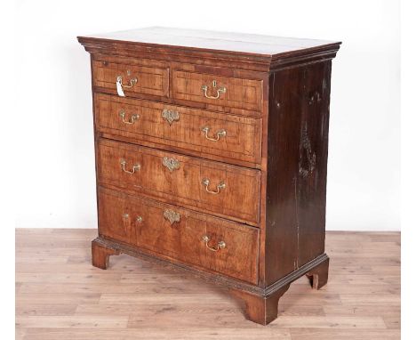 A George III walnut and oak chest of drawers, with rectangular plank top, above two short and three long graduated drawers, r