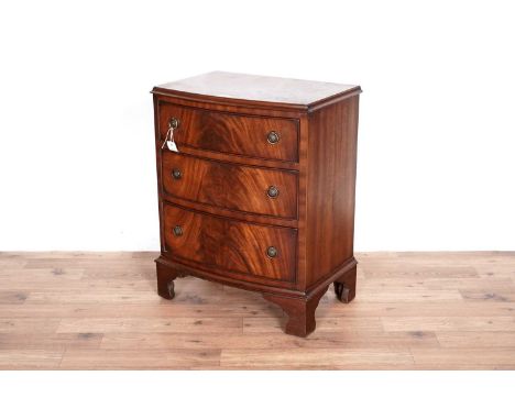 A small Georgian style mahogany bowfront chest of drawers, fitted with three long graduated drawers, raised on bracket feet, 