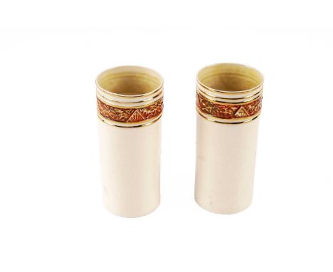 A pair of early/mid 20th Century Belleek vases, decorated with burnt orange Celtic style band, framed by gilt-coloured bands,